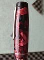 Olo-F23-RedMarbled-CapSide